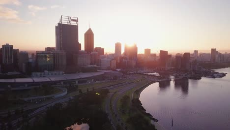 Aerial-View-of-a-Perth-Skyline-at-Sunrise-with-forward-camera-motion-towards-the-towers-and-bus-port