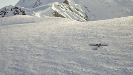Aerial-Follow-small-airplane-flying-over-snow-convered-mountain