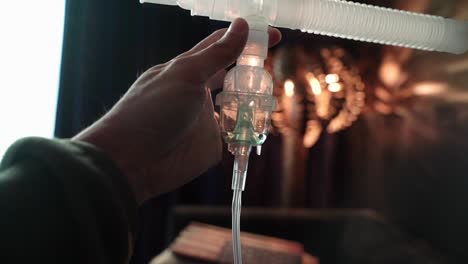 One-hand-holding-Nebulizer-assembly-with-liquid-medication-in-nebulizer-chamber