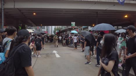 Follow-Pan-of-First-Aider-running-past-the-crowd,-Hong-Kong-protests