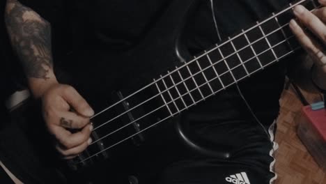 Tattooed-Bass-Player-Practices-at-Home-in-Slow-Motion