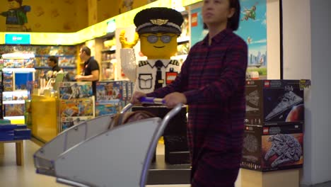 June-2019,-Istanbul,-Turkey:-dolly-in-video-of-a-giant-LEGO-police-officer-statue-in-a-toy-shop-inside-the-departure-hall-of-Istanbul-airport