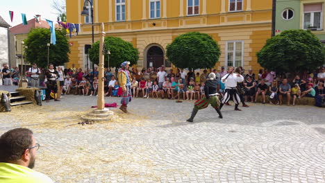 Slow-motion-of-Medieval-sword-fight-in-the-square-to-amuse-the-King,-Preludij-festival-in-Slovenj-Gradec-slovenia
