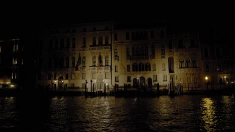 The-Regional-Council-of-Veneto-building,-Palazzo-Ferro-Fini-in-Venice,-illuminated-buildings-viewed-from-the-Grand-Canal-during-the-night
