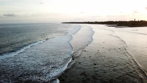 Aerial-as-waves-hit-the-beach-on-Tarawa,-Kiribiti