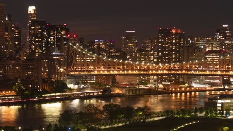 Traffic-at-FDR-Drive,-Ed-Koch-Queensboro-Bridge,-Roosevelt-Island,-East-River-and-East-Side-Manhattan-at-night---Time-Lapse,-cropped-version