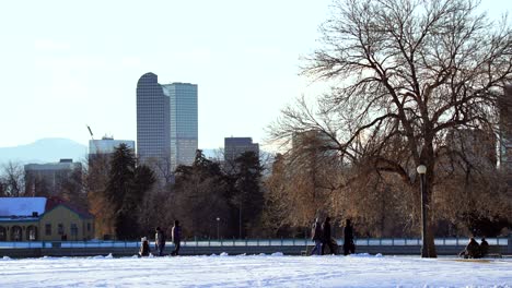 People-spending-time-in-a-park-against-a-background-of-Denver-skyline