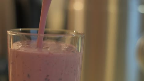 Healthy-berry-and-banana-cocktail-poured-into-glass,-close-up-shot