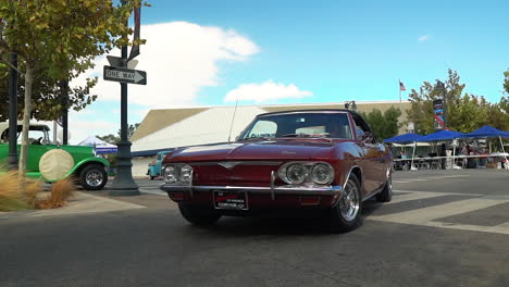 Classic-Chevy-Corvair-Corsa-drives-through-intersection-at-car-show