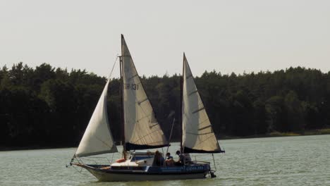 two-masted-Yacht-sailing-in-Wdzydze-Lake-in-Kaszubski-park-krajobrazowy-in-Pomeranian-Voivodeship