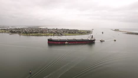 Drone-footage-of-Newcastle-harbour-and-a-ship-getting-transported-in