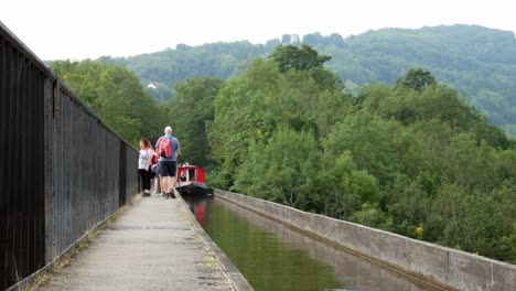Narrow-canal-boat---tourists-crossing-scenic-Pontcysyllte-aqueduct-tranquil-countryside-rural-scene