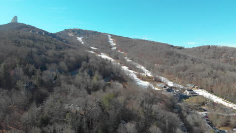 A-drone-shot-of-a-mountain-in-winter-and-the-ski-slopes