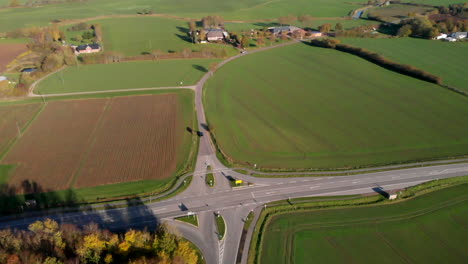 Road-intersection-in-scenic-German-countryside-landscape,-tilt-up-aerial