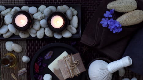 Spa-and-Wellness-Treatment-Decorations-accessories-Inspirations-with-herbal,-sponge-scrub,-aroma-candles,-plumeria-frangipani-flowers,-and-towels,-for-body-and-skin-care-therapy-and-relaxation