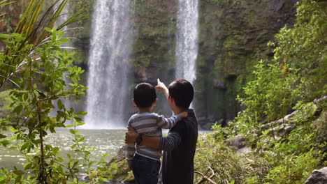 Cinemagraph-of-child-in-his-father's-arms-looks-at-waterfalls