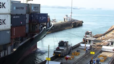 Container-ship-that-is-being-pulled-thru-the-last-chamber-of-the-Gatun-locks-into-the-Gatun-lake,-Panama-canal