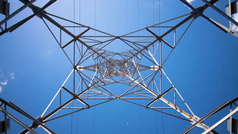 Looking-straight-up-to-electrical-pylon-from-underneath,-timelapse,-low-angle