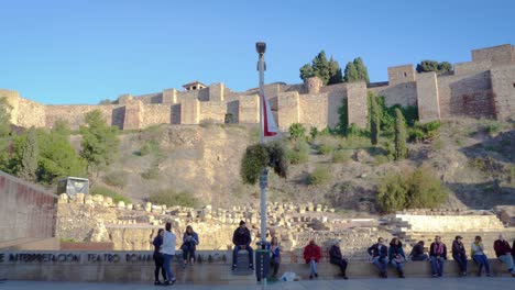 Slow-panning-shot-of-people-at-Roman-Theater-attraction-at-Alcazaba-Fortress