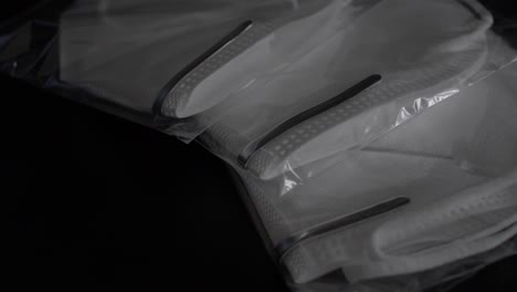Close-Up-View-Of-Three-Sealed-N95-Face-Masks-laying-On-Table