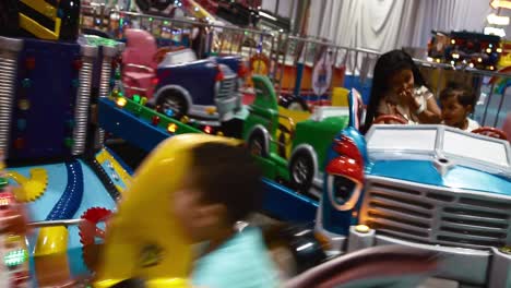 Children-Enjoying-A-Kiddie-Ride-At-The-Funfair---close-up