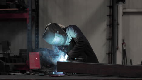 Factory-Worker-Skillfully-Welding-Metal---slow-motion-medium-shot