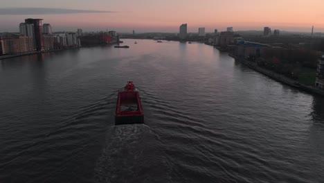 drone-follow-shot-of-Barge-boat-on-the-Thames-river-sunset