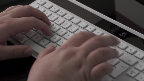 A-close-up-of-a-man's-hand-typing-on-a-keyboard