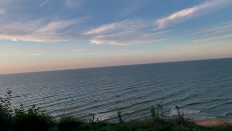 Sunset-over-the-beautiful-blue-coastal-waters-of-Jastrzębia-Góra,-Poland--pan