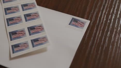 Close-Up-Pan-of-an-Envelope-and-Stamps