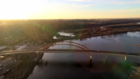 Dramatic-aerial-approach-towards-Hastings-Bridge-over-Mississippi-River,-on-a-bright-evening