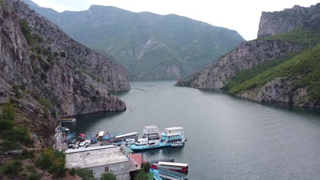 Ferry-Terminal-and-Boat-Service-in-Lake-Koman,-Albania---Aerial-Drone-View