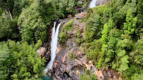 Aerial-orbit-of-the-Rio-Blanco-waterfall-in-Hornopiren-National-Park,-Chile