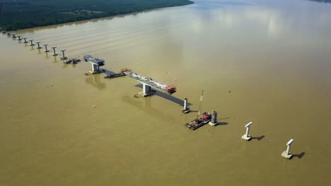Bridge-construction-crossing-river-in-perak-aerial-view