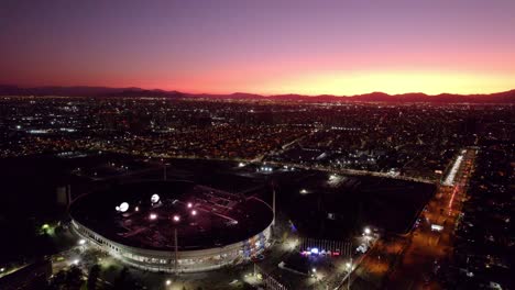 Aerial-dolly-in-revealing-live-concert-of-Coldplay-in-National-stadium-of-Santiago-at-sunset,-Chile