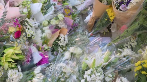 Hundreds-of-flower-bouquets-are-placed-outside-the-British-Consulate-Genera-as-mourners-queue-in-line-to-pay-tribute-to-the-passing-of-the-former-Queen-Elizabeth-II,-the-UK's-longest-serving-monarch