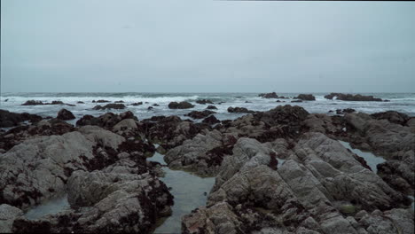 Beautiful-overcast-rocky-beach-and-waves-in-Monterey-California-4k