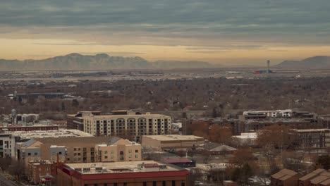 Airplanes-moving-around-the-control-tower,-taking-off-and-landing---time-lapse-of-an-airport-from-the-distant-downtown-Salt-Lake-City