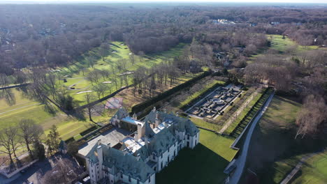 An-aerial-view-over-an-upscale,-luxury-mansion-with-an-eight-reflection-pool-fountain,-on-Long-Island,-NY