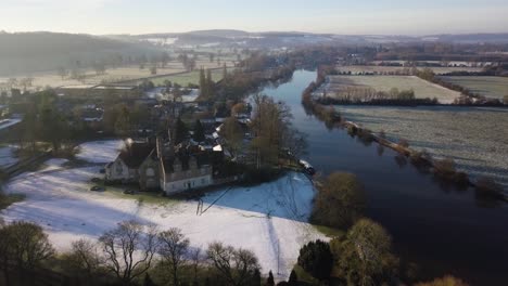 Aerial-footage-over-river-thames-on-a-snowy,-wintery-morning