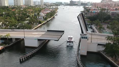 Aerial-of-big-boat-driving-under-a-bridge