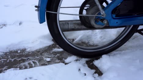 Retro-moped-making-wheel-spin-on-ice