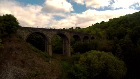 Aerial-view-of-sunset-at-Headstone-Viaduct,-bridge,-the-Peak-District-National-Park,-Bakewell,-commonly-used-by-cyclists,-hikers,-popular-with-tourists-and-holiday-makers