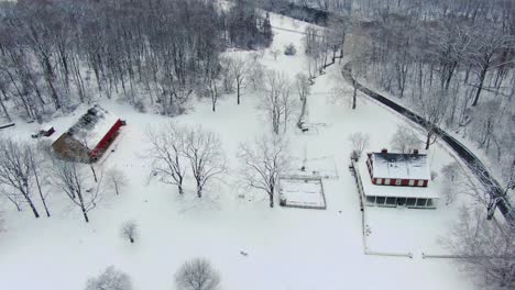 Aerial,-high-altitude-view-of-snow-covered-Rock-Ford-Plantation-in-Winter,-home-to-General-Edward-Hand,-a-historic-site-in-Lancaster-County-and-important-place-in-the-American-Revolution