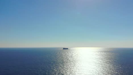 Drone-shot-over-the-sea-overlooking-Filfla-island-in-the-Mediterranean-sea