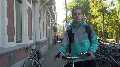 Clip-of-a-deliveroo-rider-walking-in-a-street-of-Rotterdam-while-smiling