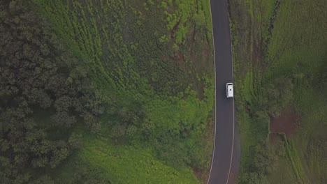 Aerial-footage-of-a-cmapervan-driving-along-the-open-coastline