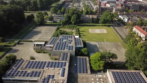 Drone-view-of-a-school-covered-in-solar-panels-in-Dronten,-Flevoland,-The-Netherlands