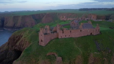 Aerial-footage-of-Dunnottar-Castle-at-dawn,-Aberdeenshire,-Scotland