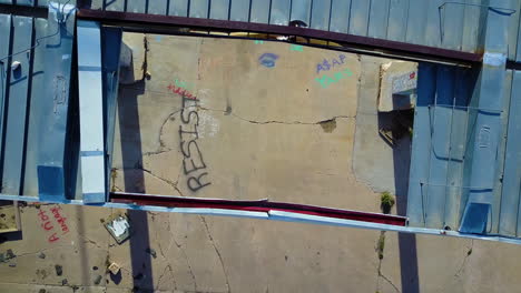 Birds-eye-view-of-an-abandoned-and-derelict-service-station-with-obscene-graffiti